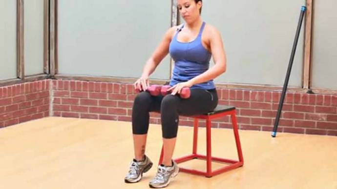 Sitting calf raise with dumbbell
