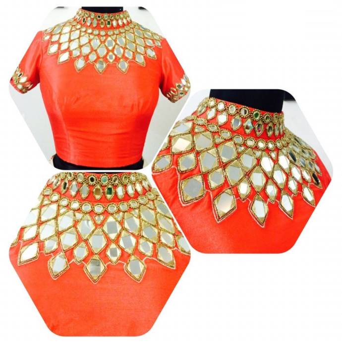 High-neck orange blouse with half- mirror work