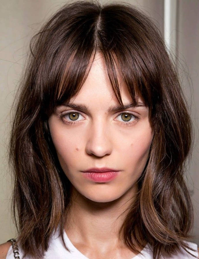 Mid part hairstyle with wide swept fringe hairstyle