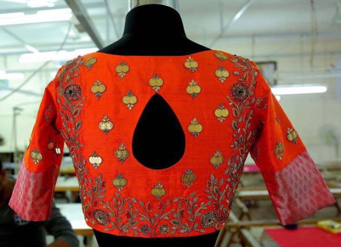 Orange blouse with red zari and maggam work